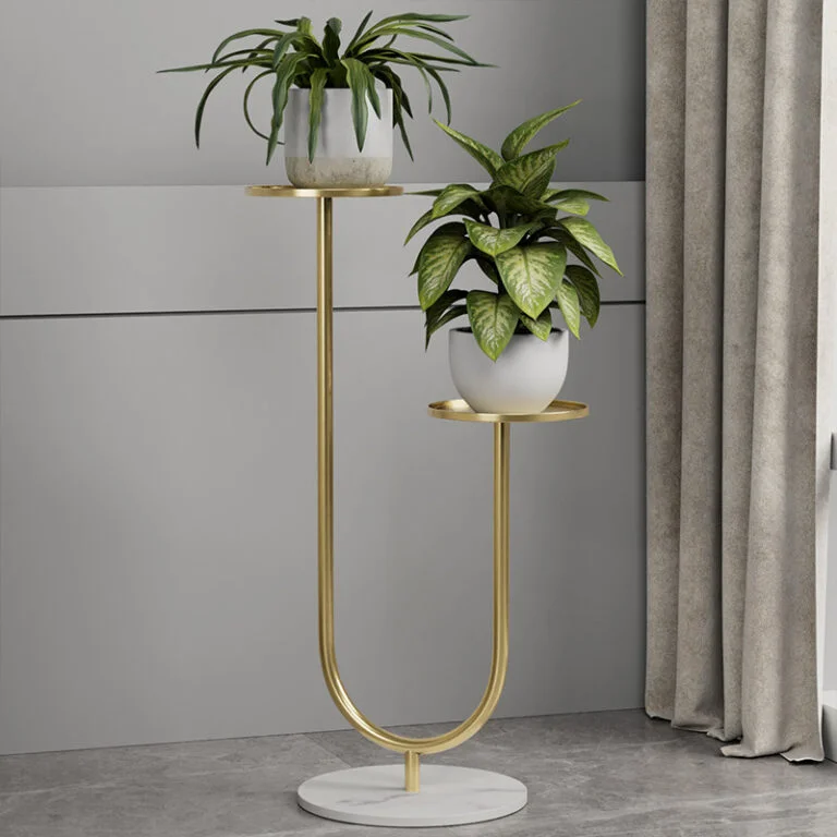 Modern gold metal planter with two potted plants on a marble base, ideal for luxury home decor.