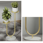 Modern gold and marble indoor planter with green plants for luxury home decor.