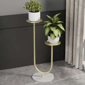 Modern gold metal planter with two plants on a marble base, ideal for luxury home decor.