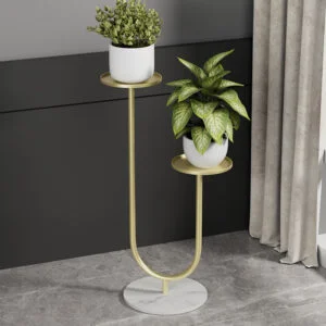 Modern gold metal planter with two plants on a marble base, ideal for luxury home decor.