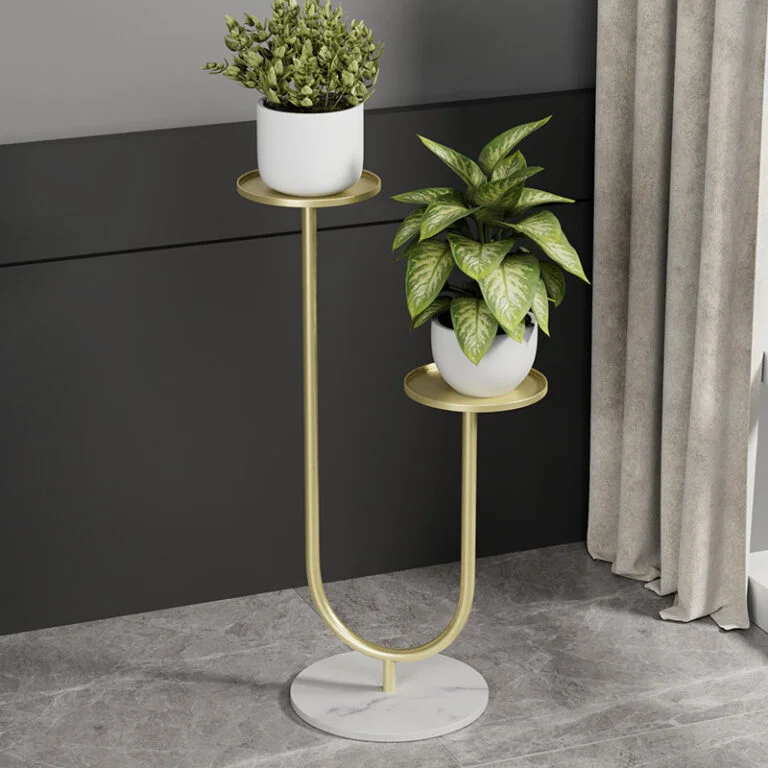 Modern gold metal planter with two plants on a marble base, ideal for luxury home decor.