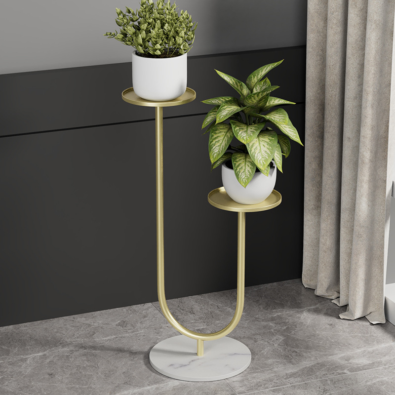 Gold Metal Planter with Marble Base Modern gold metal planter with two plants on a marble base, ideal for luxury home decor.