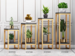 Modern gold and black plant stands with decorative indoor planters and green plants.