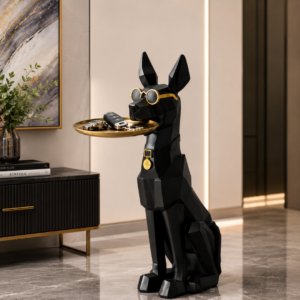 Modern black dog sculpture holding a gold tray in a luxury home setting.
