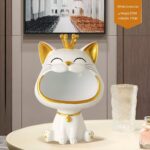 White crown cat figurine with gold accents on a table, modern home decor.