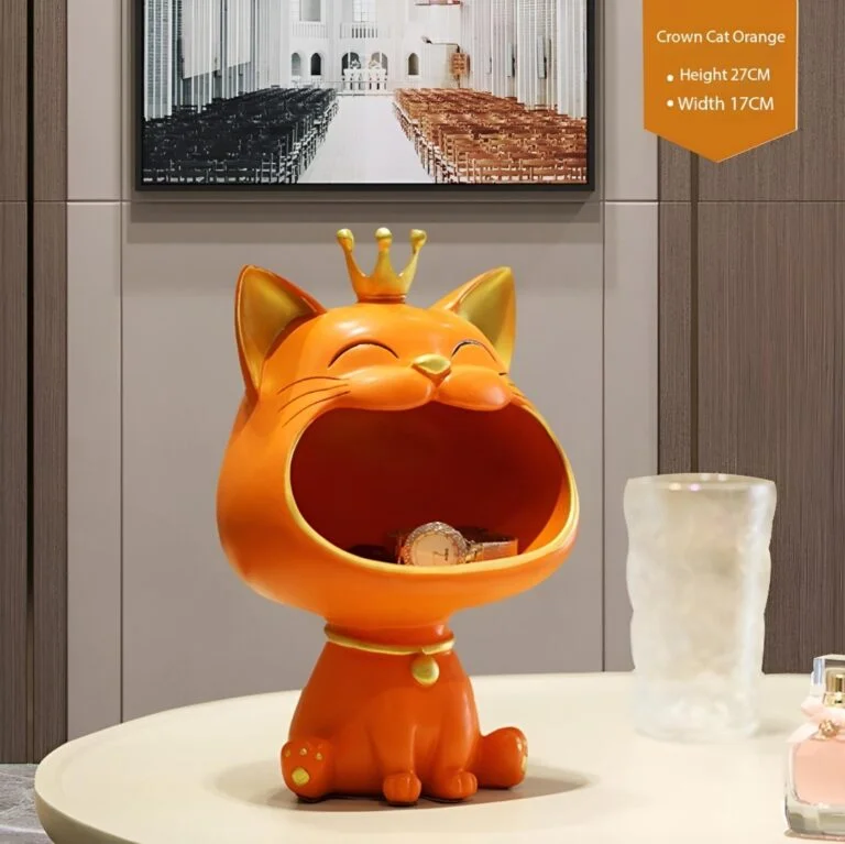 Orange cat figurine with crown on table, modern home decor accessory.