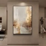 Modern luxury framed wall art in a living room setting, featuring abstract design with gold accents.