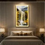 Illuminated modern wall art with waterfall scene in a luxury bedroom setting.