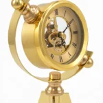 Ornate brass tripod clock with visible gears, modern luxury home decor accessory.
