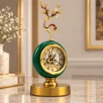 Ornate green clock with floral finial on a gold base, modern home decor accessory.