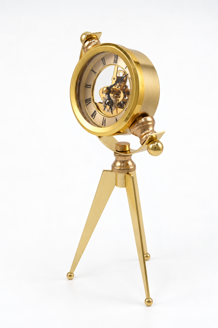 Vintage golden steampunk tripod clock with exposed gears and Roman numerals.